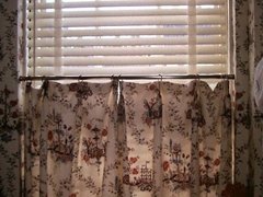 White wooden blind with cafe curtain