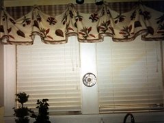 White wooden blinds with valance on board